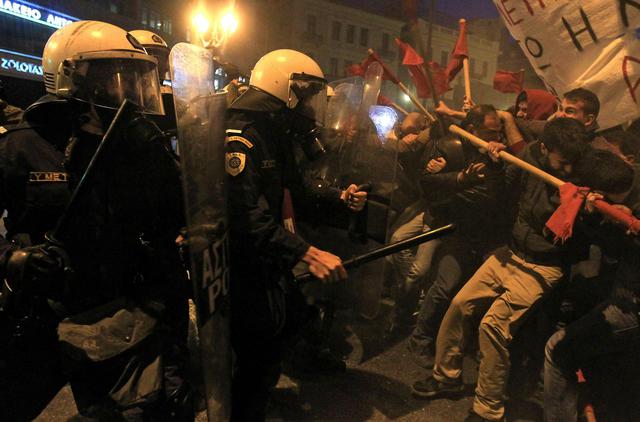 Protesters clash with riot police during a protest in Athens